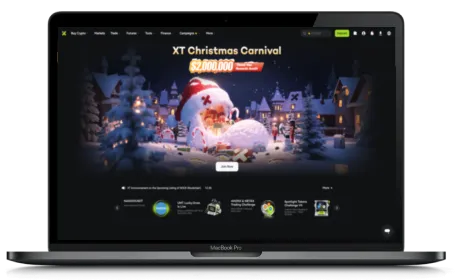 XT.COM website displayed on a Macbook